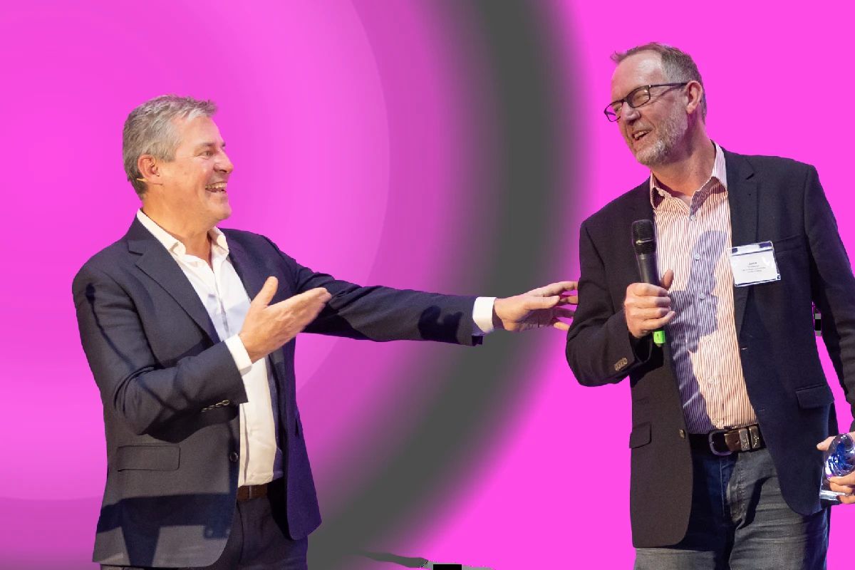 Michael sharing a laugh with an award winner on stage